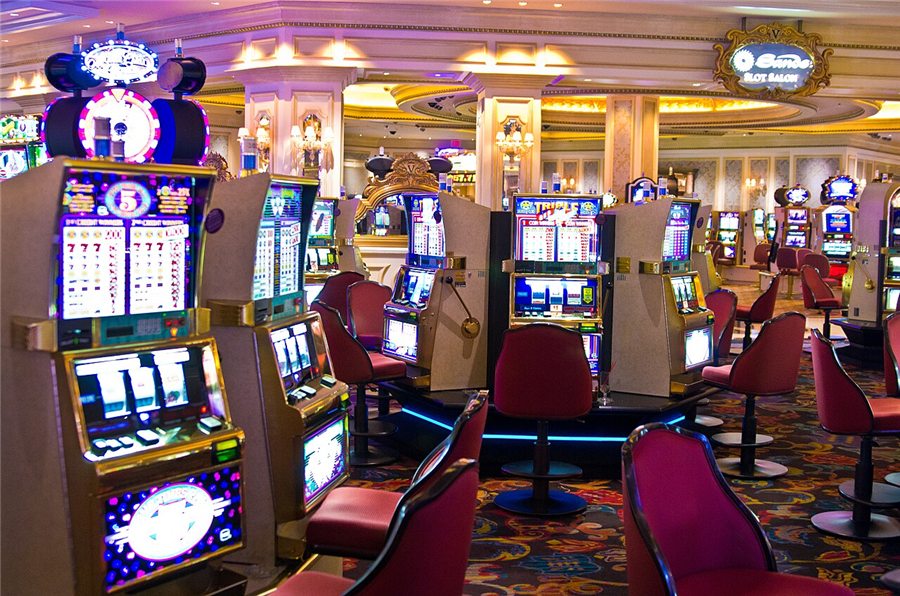 A row of slot machines on a casino floor