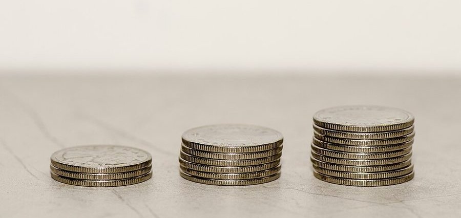 Three stacks of Canadian coins of increasing height