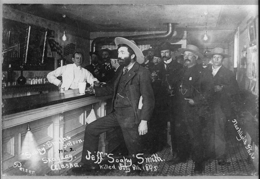 Soapy Smith standing at the bar of his saloon in Skagway, Alaska, 1898